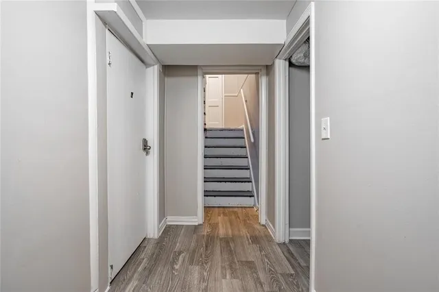 a view of a hallway with wooden floor and staircase