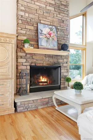 a living room with a fireplace and a large window