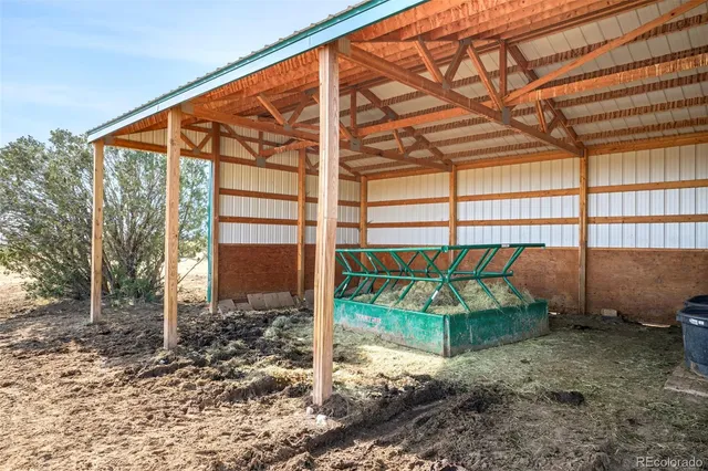 a backyard of a house with plants and outdoor seating
