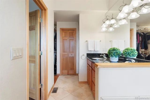 a kitchen with stainless steel appliances granite countertop a sink and a refrigerator