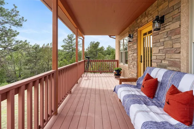 a balcony with furniture and wooden floor