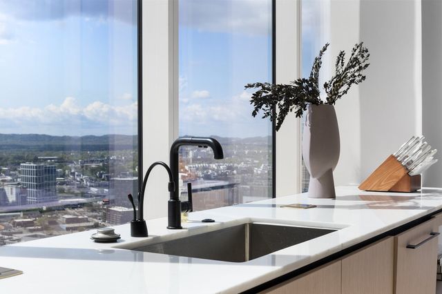 a living room with furniture a rug and white walls