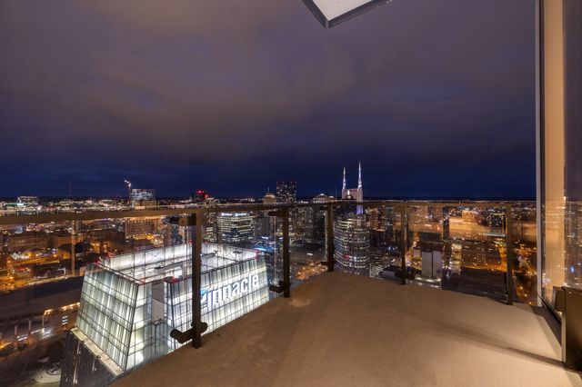 a living room with furniture a large tree and a table