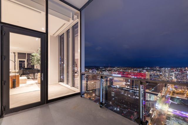 a view of a balcony with chairs and a potted plant
