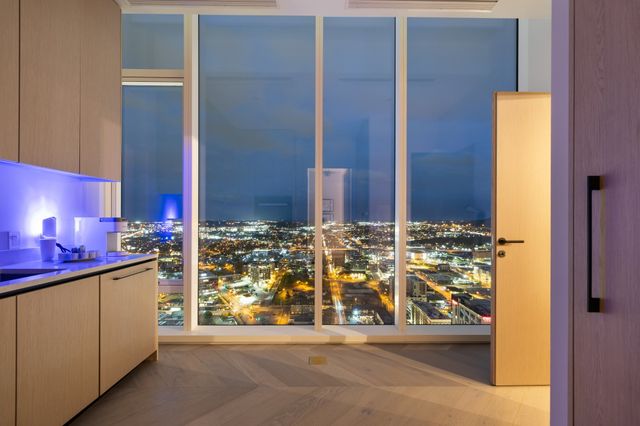 a view of a hallway with white walls and stairs