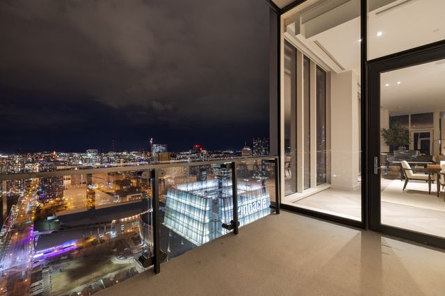 a bedroom with bed and a large window