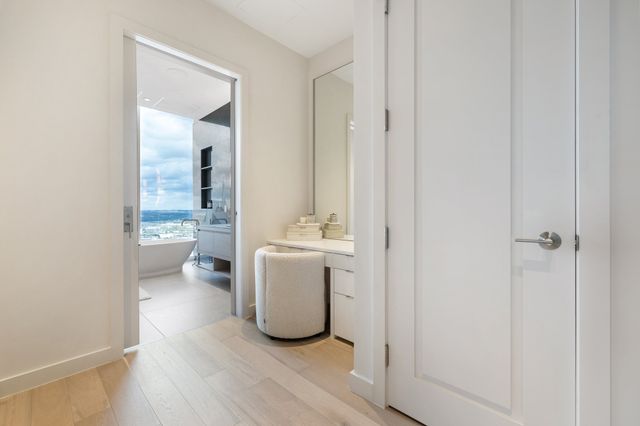 a bathroom with double vanity and a bathtub