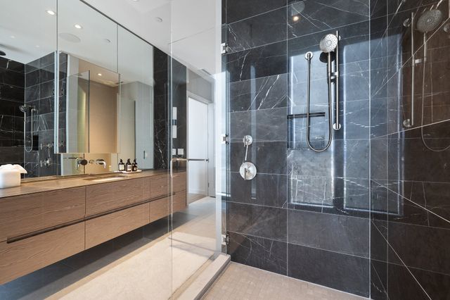 a bedroom with a bed and a flat tv screen on wall