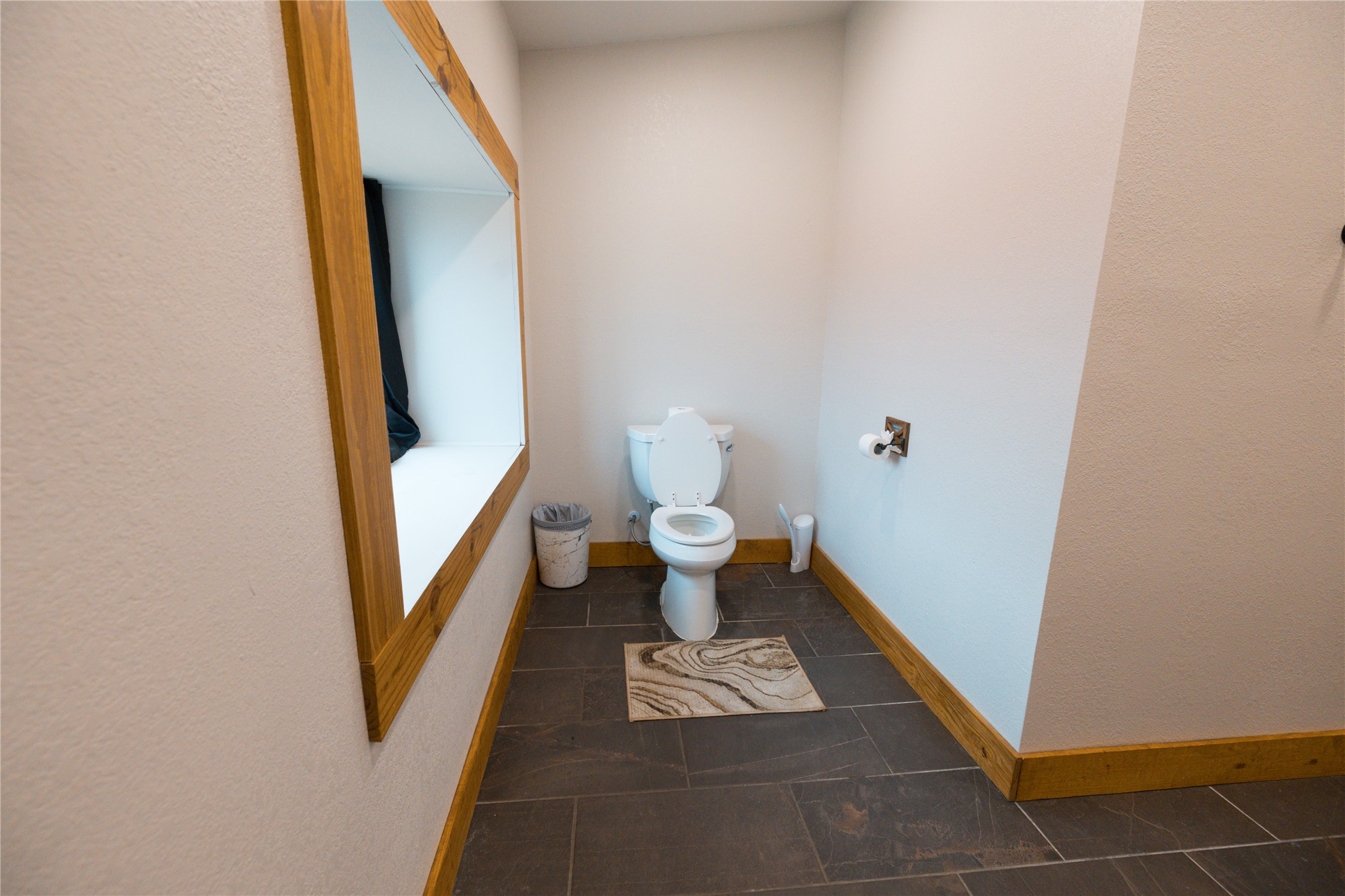 143 County Road Paige, TX 78659 - Photo 14 of 36 Upstairs Bathroom with a textured wall and dark tile patterned floors