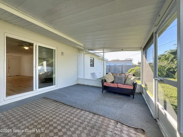 a bedroom with furniture and a large window