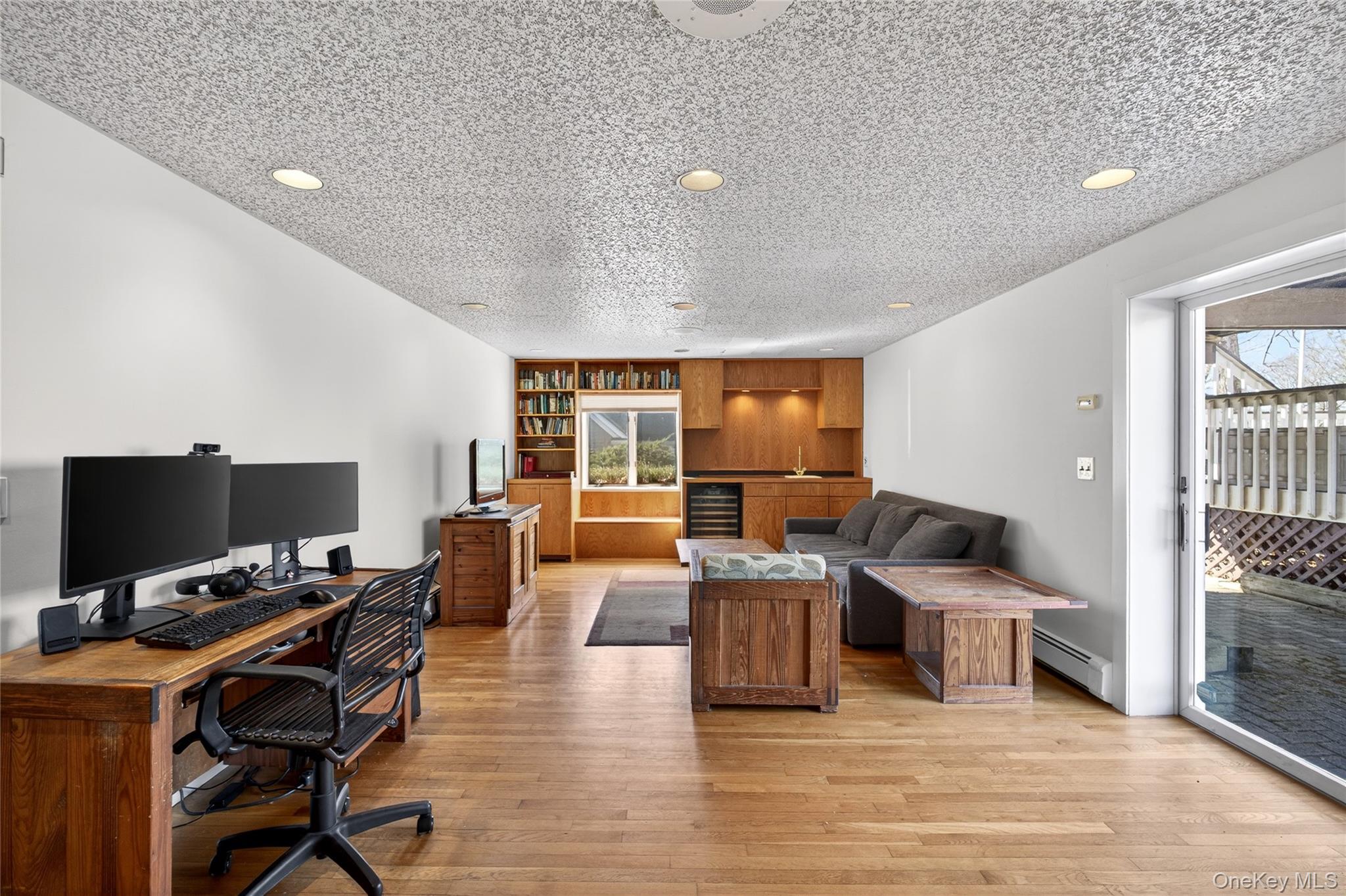 80 Ridgeview Drive Pleasantville, NY 10570 - Photo 26 of 45 Lower level entertaining Room with Fireplace and Built-Ins as well as sliders to the patio and backyard