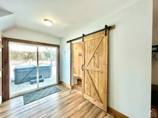 a view of a room with wooden floor and windows