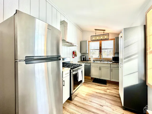 a kitchen with a refrigerator sink and stove top oven