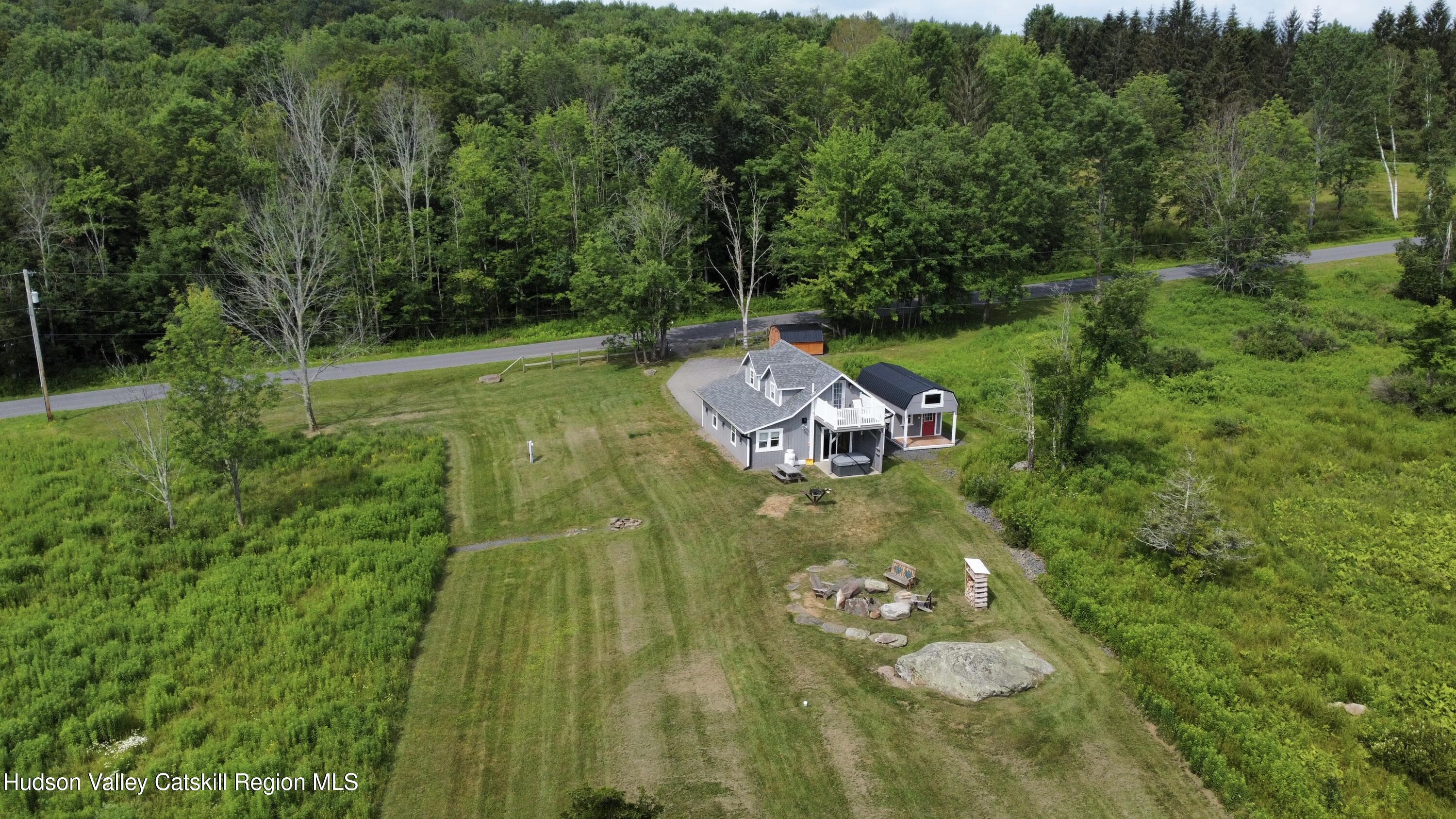 462 Dent Road Prattsville, NY 12468 - Photo 21 of 32 a backyard of a house with table and chairs a fire pit
