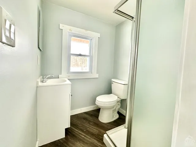 a bathroom with a sink toilet and a window