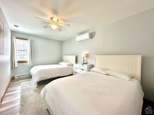 a bedroom with two beds and a chandelier