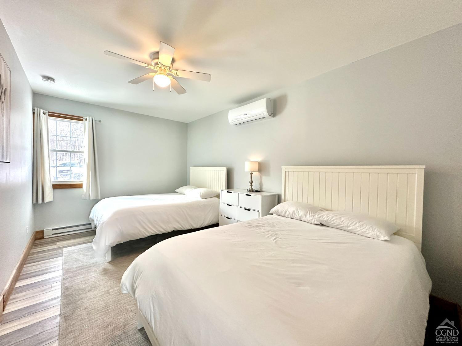 462 Dent Road Prattsville, NY 12468 - Photo 9 of 32 a bedroom with two beds and a chandelier