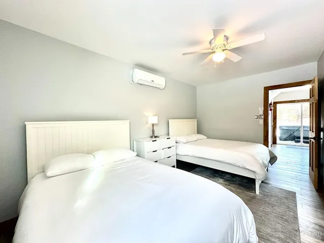 a bedroom with a bed and a chandelier