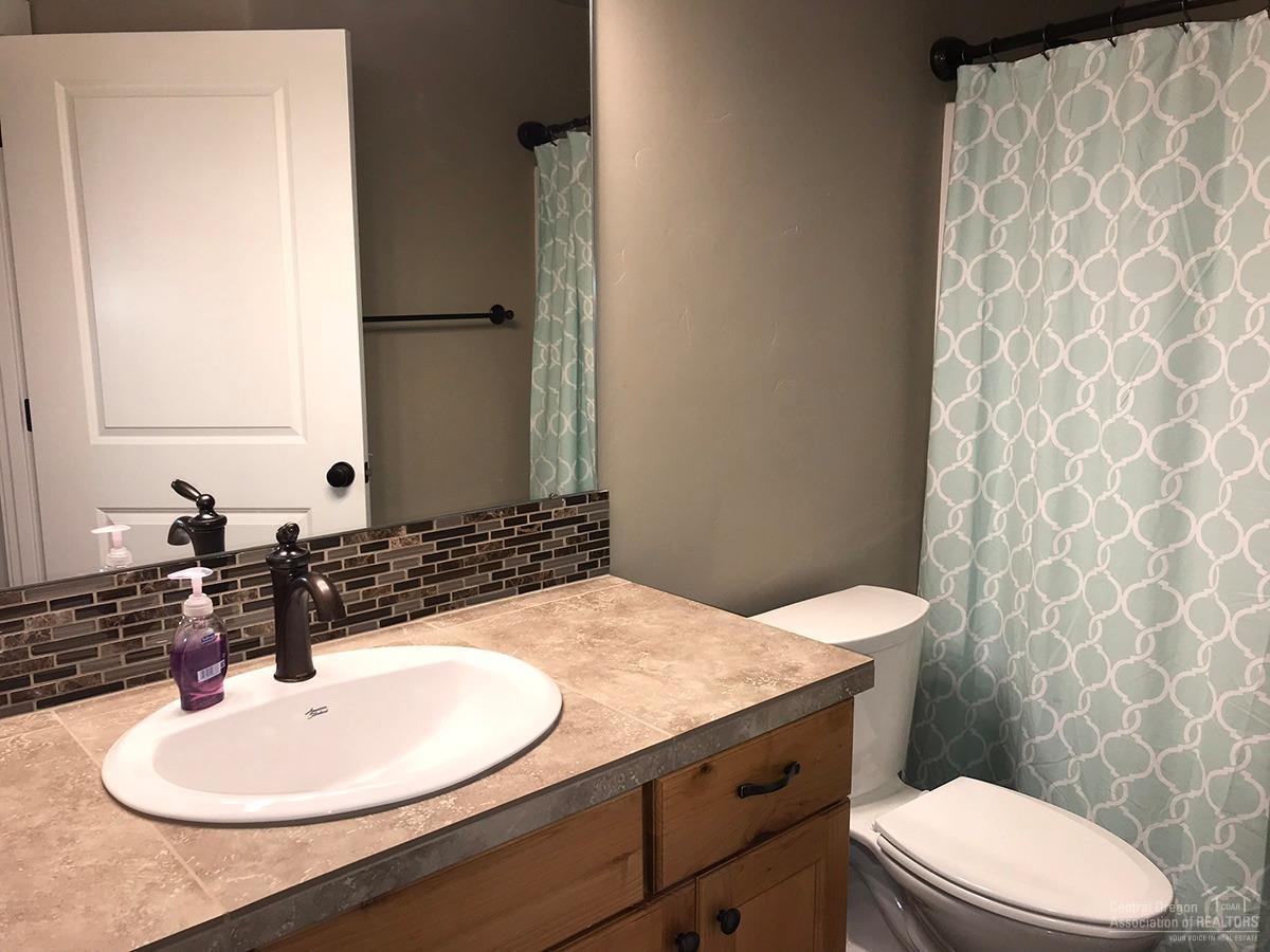 16923 Indio Road Bend, OR 97707 - Photo 23 of 24 The guest bathroom offers travertine til