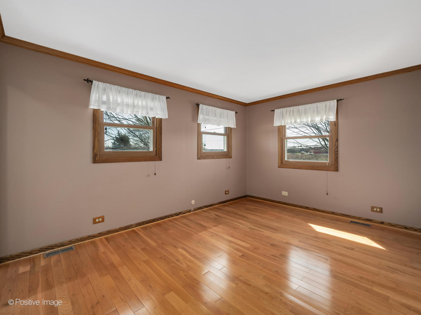 390 Arrowhead Trail Carol Stream, IL 60188 - Photo 11 of 25 a view of an empty room with window and wooden floor