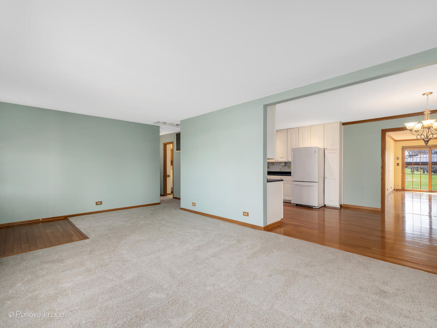 390 Arrowhead Trail Carol Stream, IL 60188 - Photo 4 of 25 an empty room with window and wooden floor