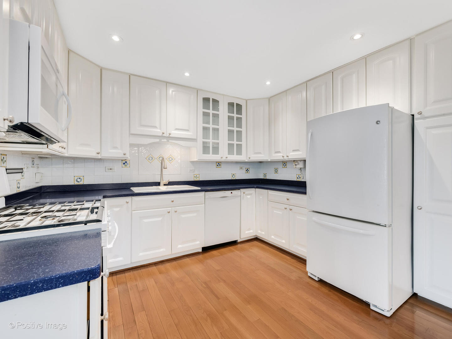 390 Arrowhead Trail Carol Stream, IL 60188 - Photo 8 of 25 a kitchen with granite countertop white cabinets and white appliances