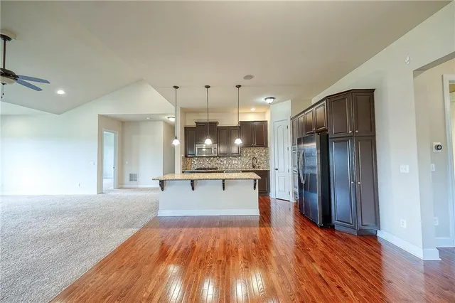 a large kitchen with stainless steel appliances kitchen island granite countertop a large counter top and stove