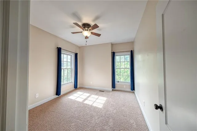 a spacious bathroom with a double vanity sink a large mirror and a shower