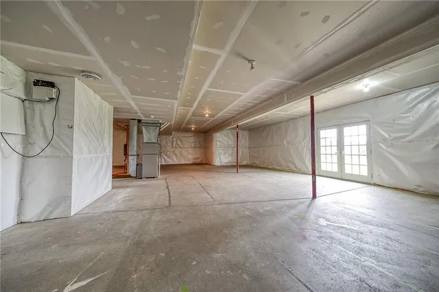a view of a big yard with plants and large trees