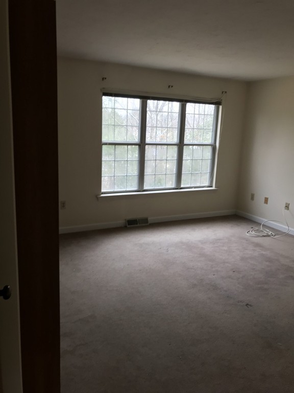 103 Ridgefield Circle, Unit C Clinton, MA 01510 - Photo 7 of 15 a view of an empty room with a window