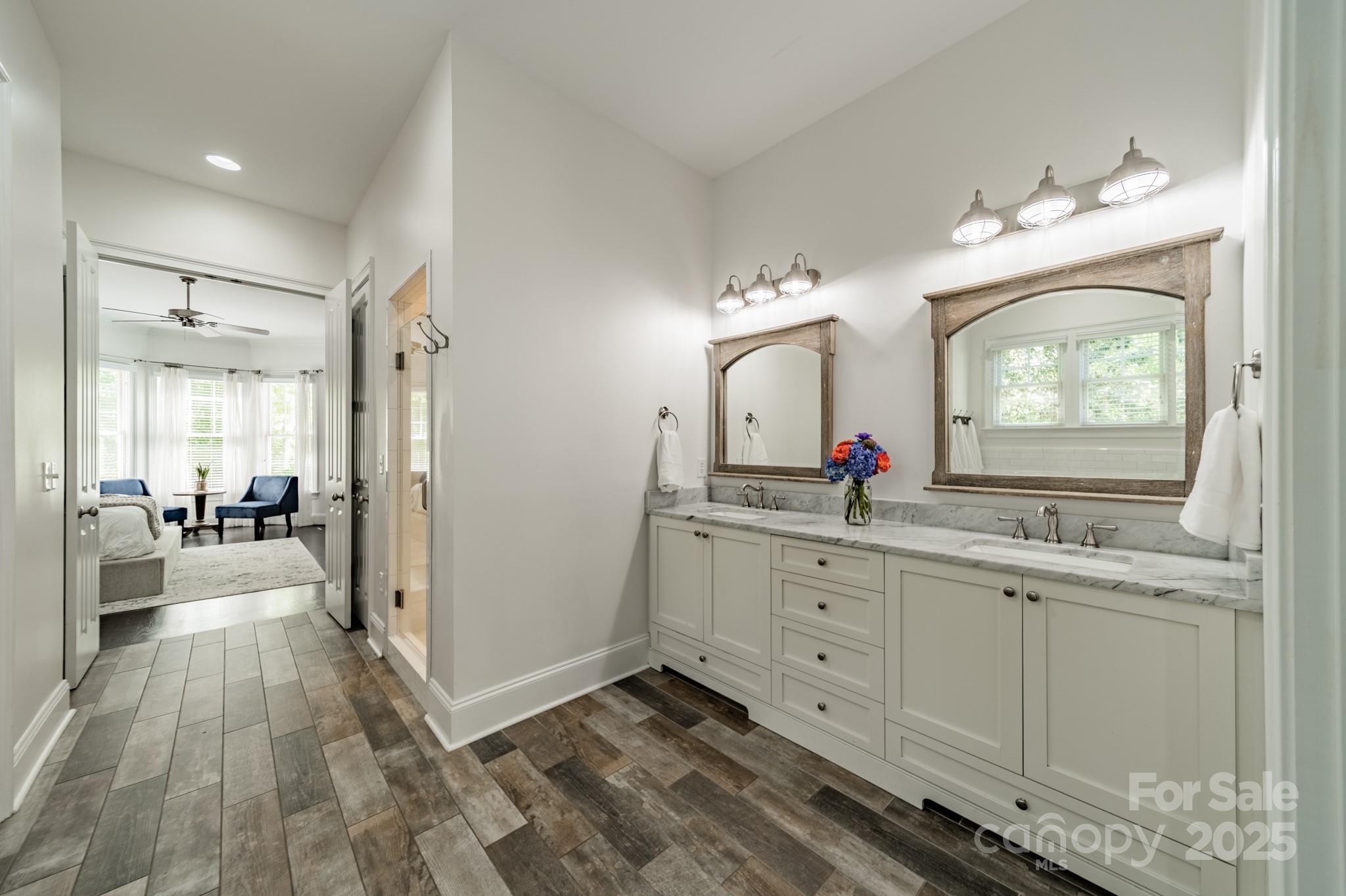 5868 Savona Terrace Fort Mill, SC 29708 - Photo 24 of 46 a spacious bathroom with a granite countertop sink mirror and a bathtub