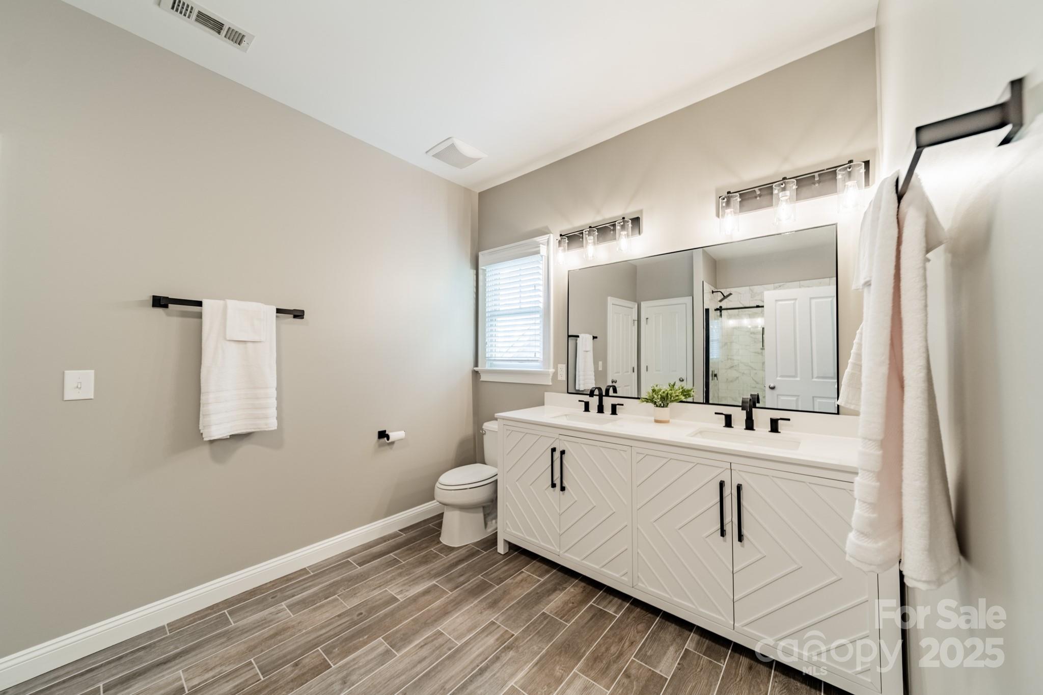 5868 Savona Terrace Fort Mill, SC 29708 - Photo 32 of 46 a bathroom with a double vanity sink mirror and toilet