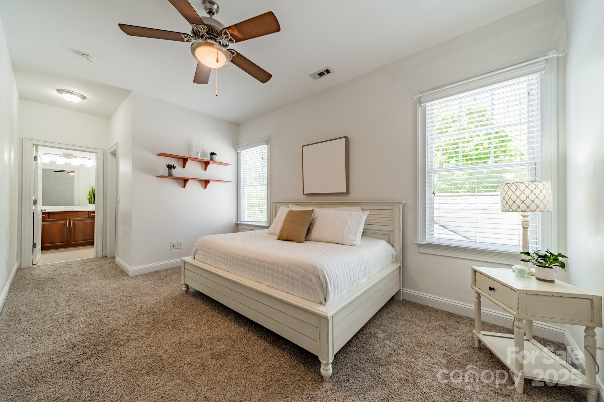 5868 Savona Terrace Fort Mill, SC 29708 - Photo 34 of 46 a bedroom with a bed and a chandelier fan