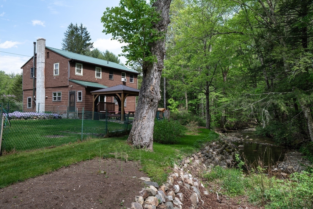 425 Dingle Road Worthington, MA 01098 - Photo 27 of 32 a view of house in front of a big yard with large trees