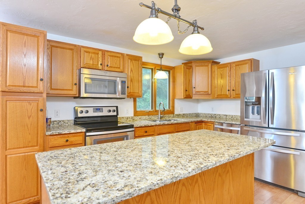 3 Bog Iron Road Wareham, MA 02576 - Photo 11 of 25 a kitchen with stainless steel appliances granite countertop a sink stove and refrigerator