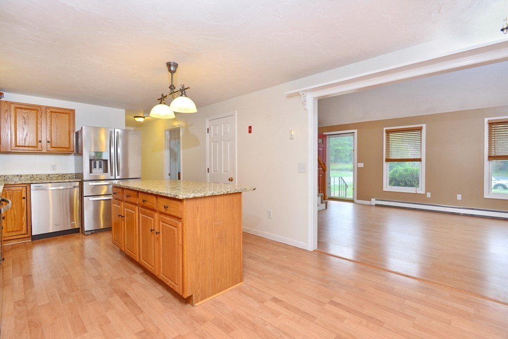 3 Bog Iron Road Wareham, MA 02576 - Photo 10 of 25 a large kitchen with stainless steel appliances granite countertop a stove a sink dishwasher a refrigerator and white cabinets with wooden floor