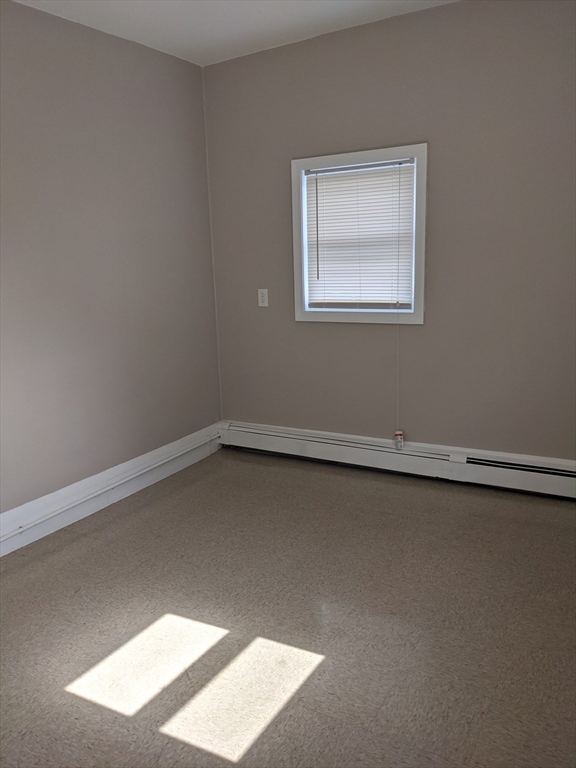 66 Batchelder Street, Unit 2 Boston, MA 02119 - Photo 4 of 8 an empty room with a window