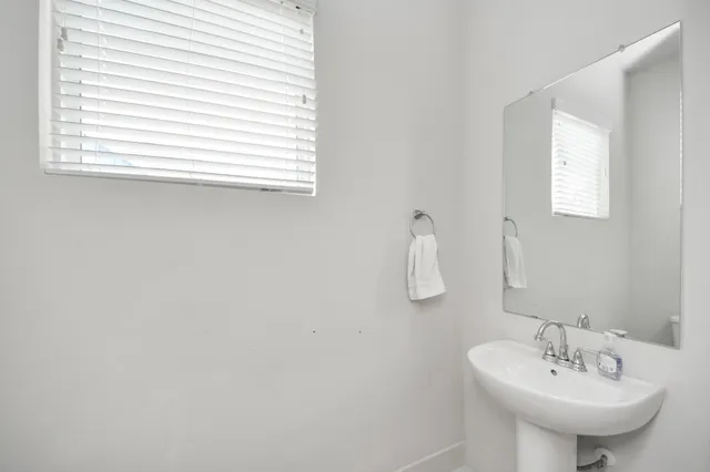 a large white kitchen with a lot of white cabinets and stainless steel appliances