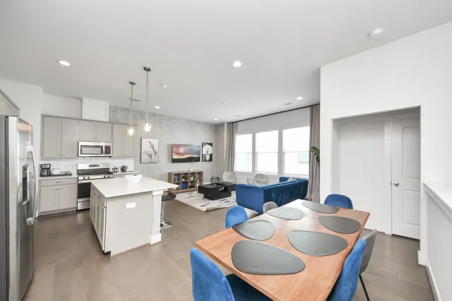 a kitchen with stainless steel appliances a sink a stove top oven a counter space and cabinets