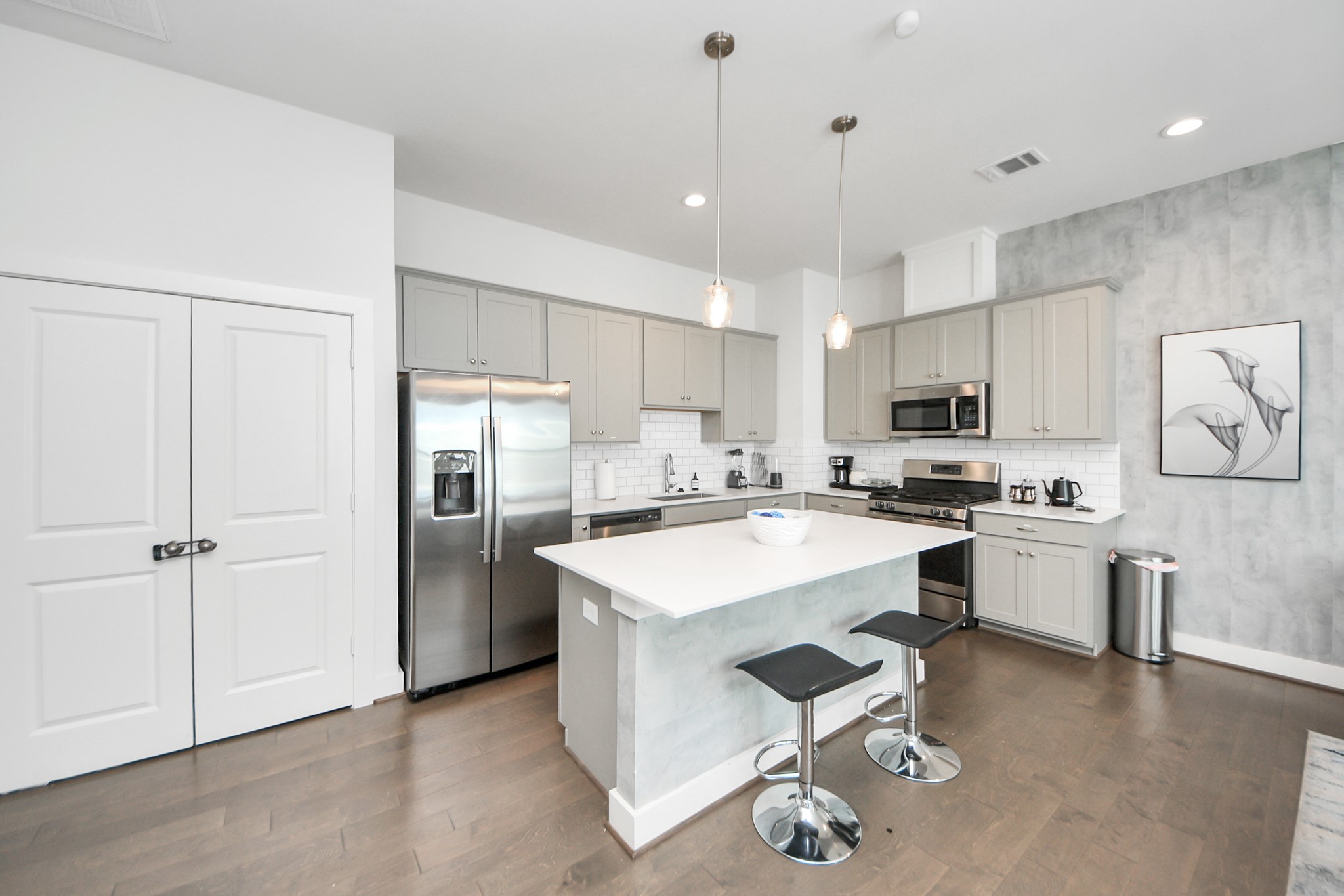 3642 Griggs Road Houston, TX 77021 - Photo 19 of 39 a kitchen with a refrigerator a sink dishwasher a stove and white cabinets with wooden floor