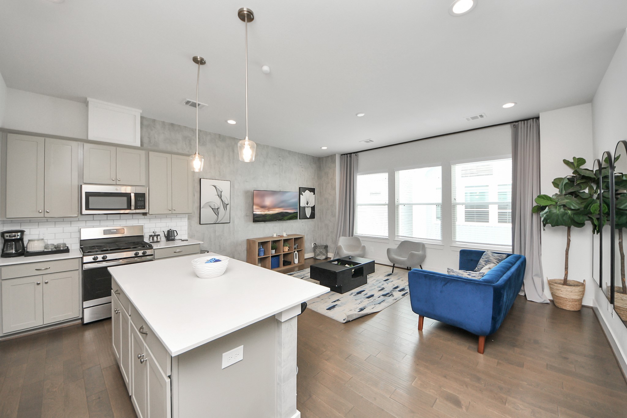 3642 Griggs Road Houston, TX 77021 - Photo 20 of 39 a living room with stainless steel appliances kitchen island granite countertop a stove a sink a refrigerator and a living room with wooden floor