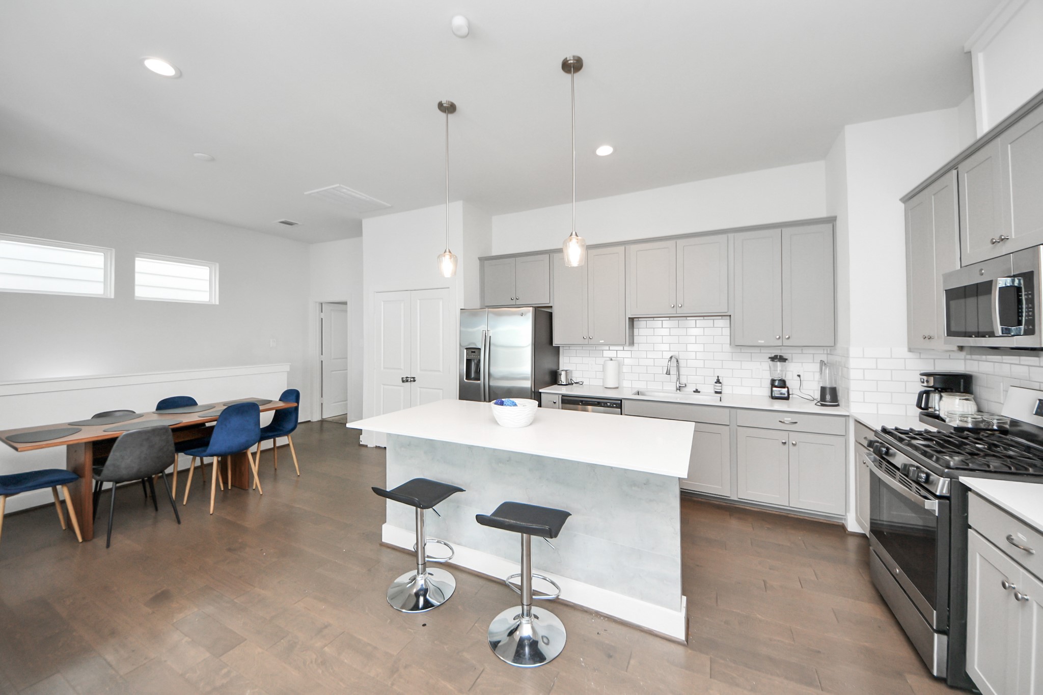 3642 Griggs Road Houston, TX 77021 - Photo 24 of 39 a large kitchen with kitchen island a sink a stove a dining table and chairs