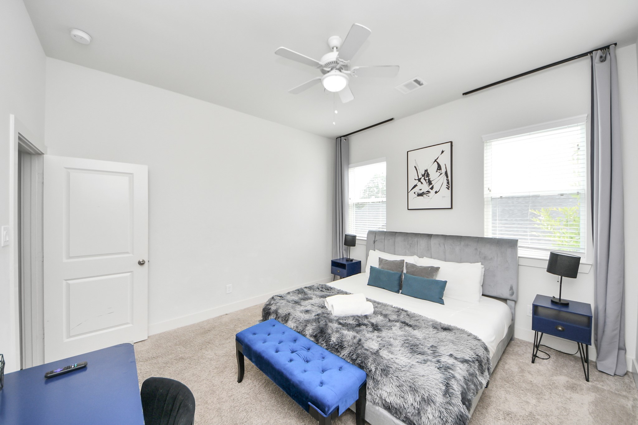 3642 Griggs Road Houston, TX 77021 - Photo 32 of 39 a bedroom with a bed and a large window with wooden floor