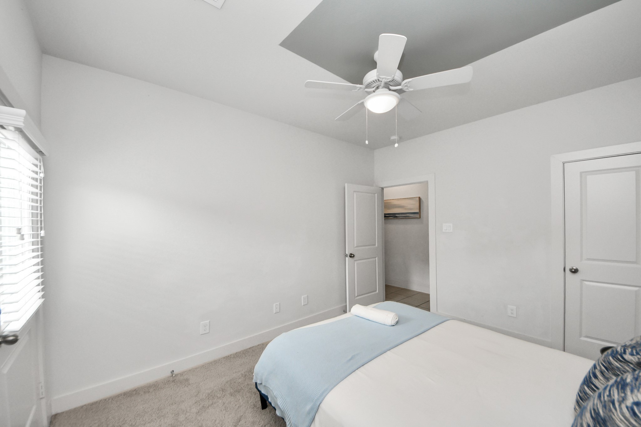 3642 Griggs Road Houston, TX 77021 - Photo 9 of 39 a bedroom with a large bed and a chandelier