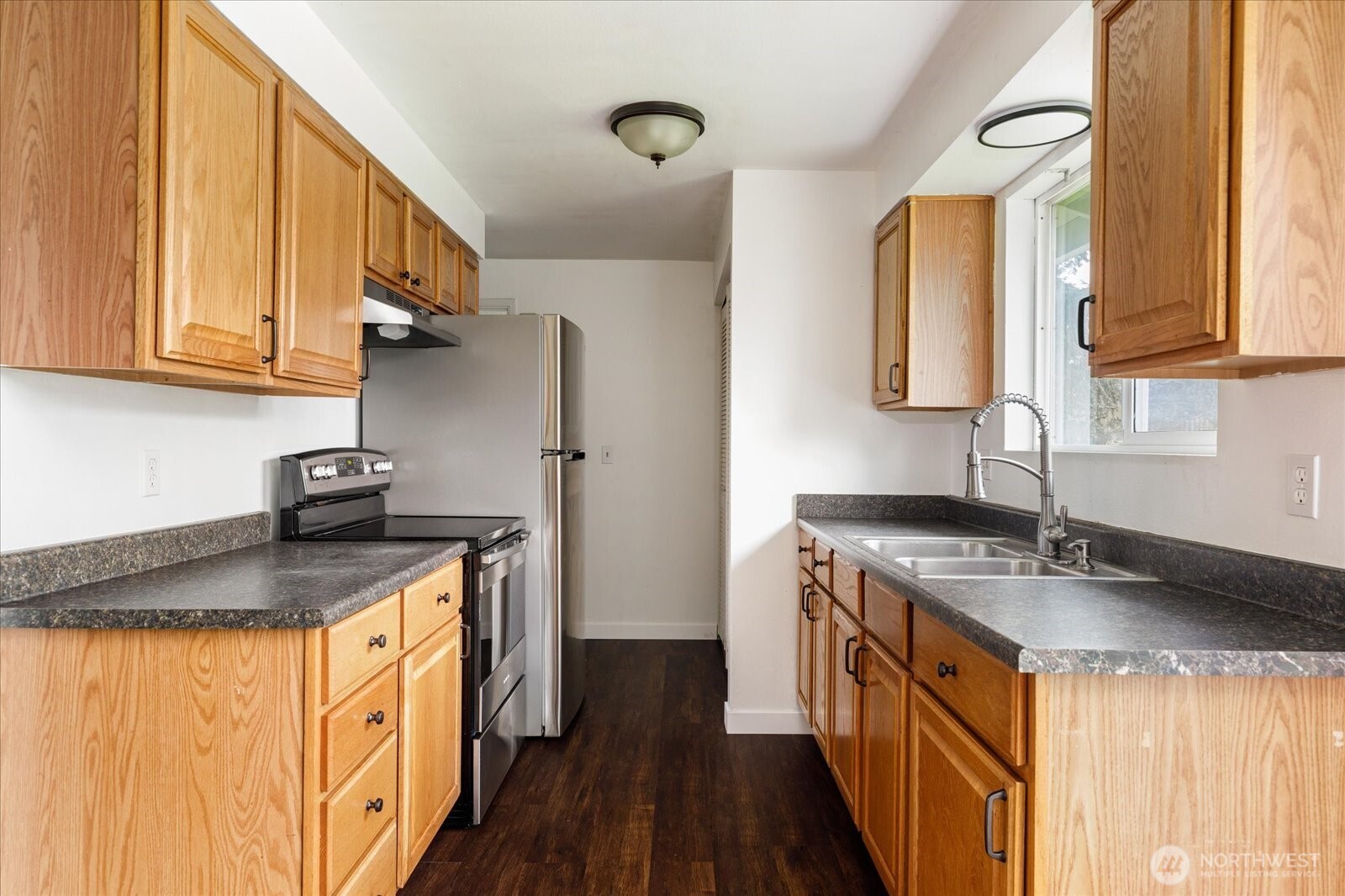 1146 Ridgeway Drive Oak Harbor, WA 98277 - Photo 12 of 25 a kitchen with stainless steel appliances granite countertop a sink stove and refrigerator