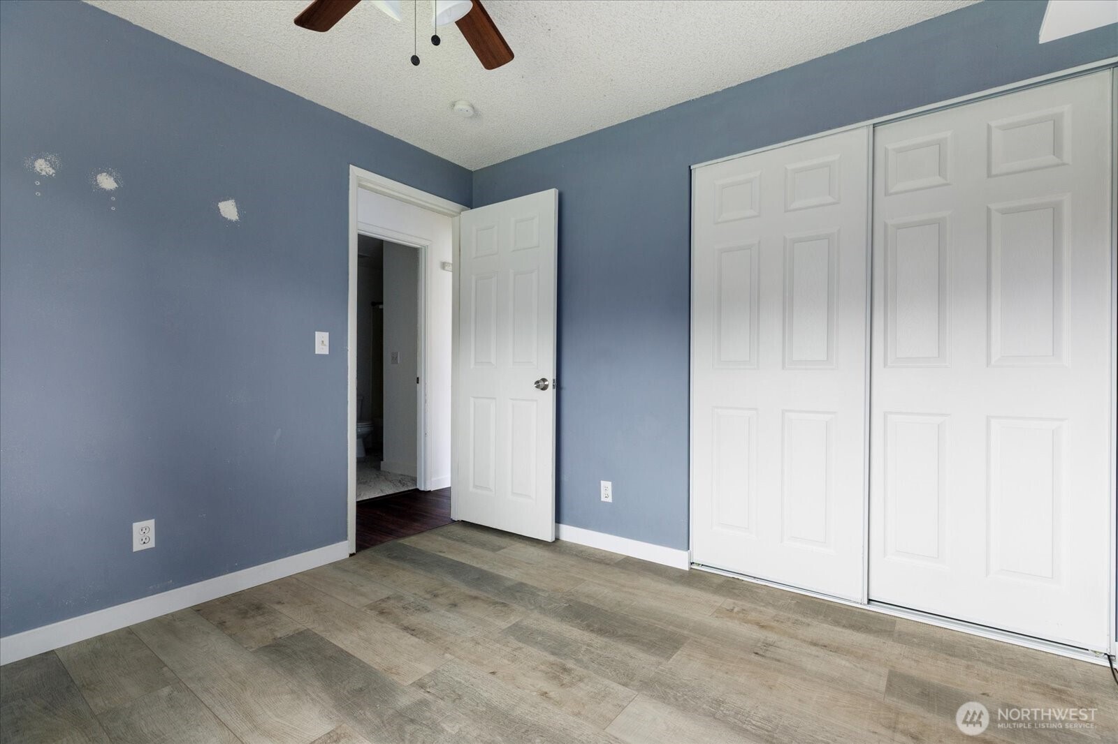 1146 Ridgeway Drive Oak Harbor, WA 98277 - Photo 15 of 25 an empty room with a ceiling fan and carpet