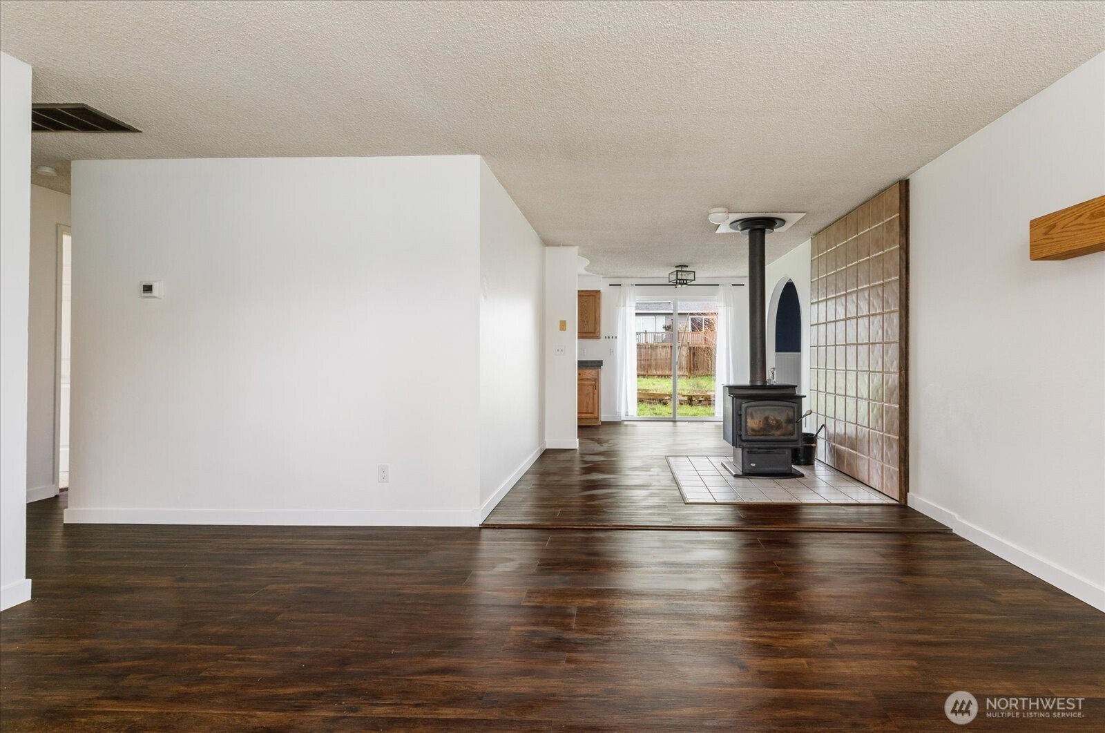 1146 Ridgeway Drive Oak Harbor, WA 98277 - Photo 6 of 25 a view of an empty room with wooden floor and a window