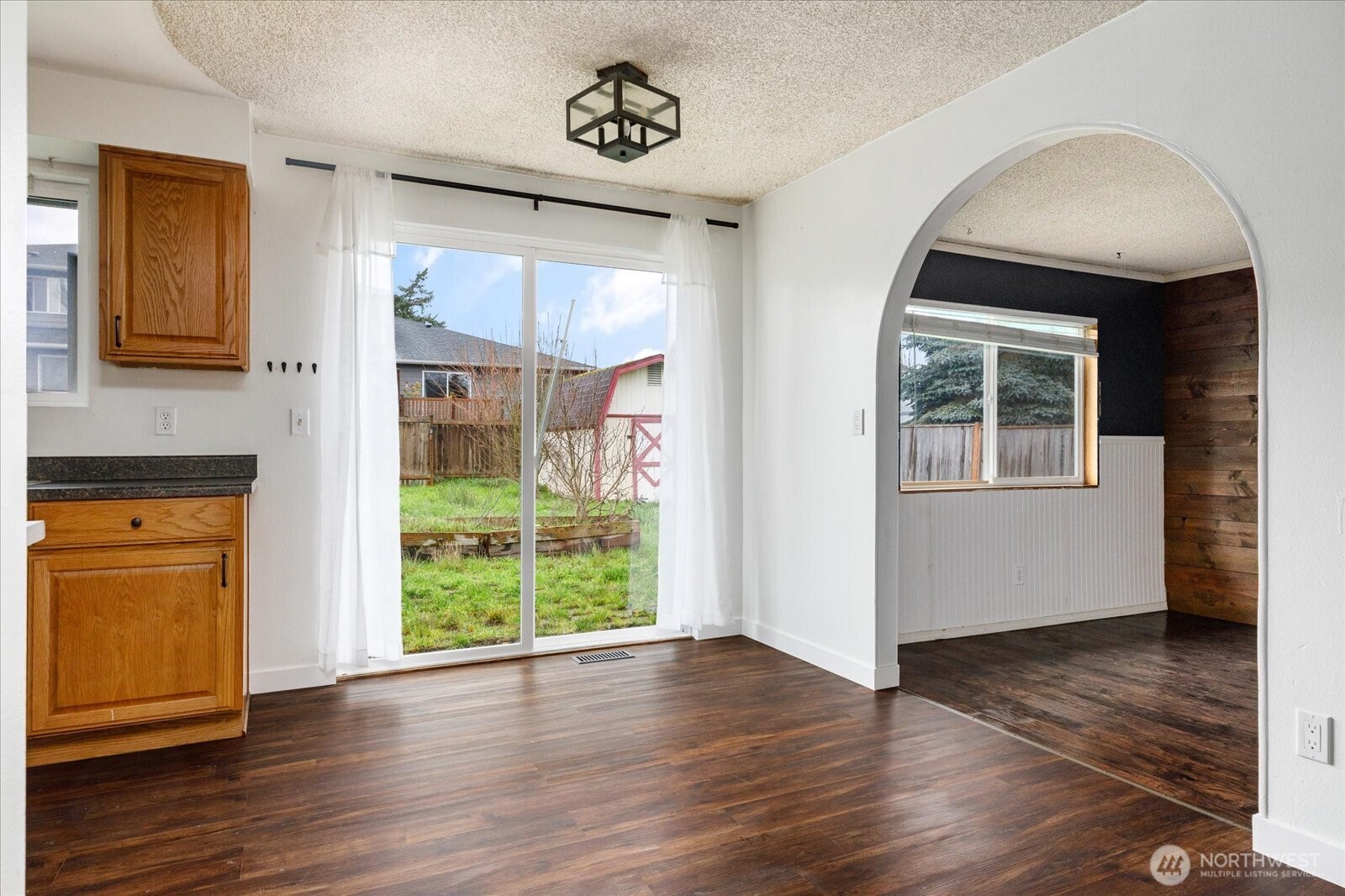 1146 Ridgeway Drive Oak Harbor, WA 98277 - Photo 8 of 25 an empty room with wooden floor and windows
