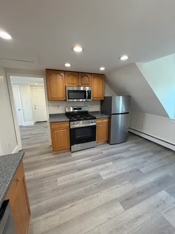 a kitchen with stainless steel appliances a stove a sink and a refrigerator