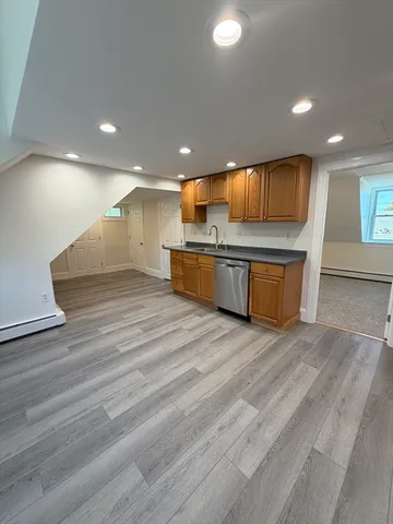 a open kitchen with stainless steel appliances granite countertop a stove a sink and a refrigerator